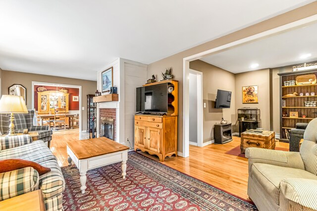 28 Blakeman Dr, Monroe, CT 06468 - living area featuring a brick fireplace, wood finished floors, baseboards, and recessed lighting