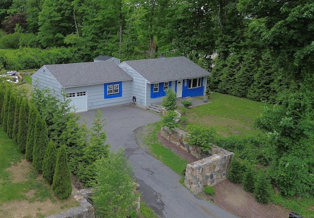 112 Clapboard Ridge Rd, Danbury, CT 06811 - view of front facade featuring driveway, roof with shingles, a garage, and a view of trees