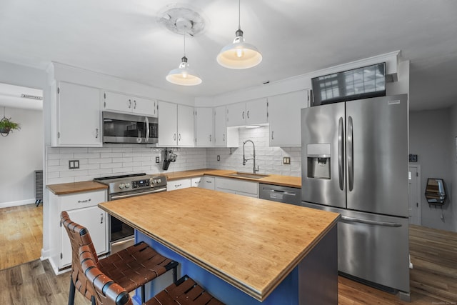 38 Rossie St, Stonington, CT 06355 - kitchen featuring appliances with stainless steel finishes, wooden counters, dark wood-style floors, and backsplash