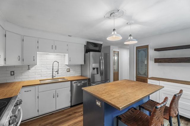 38 Rossie St, Stonington, CT 06355 - kitchen with appliances with stainless steel finishes, wood counters, tasteful backsplash, and open shelves
