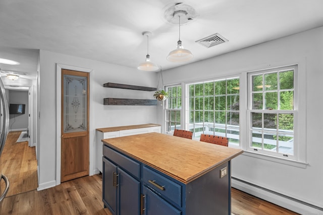 38 Rossie St, Stonington, CT 06355 - kitchen featuring a baseboard radiator, blue cabinets, dark wood finished floors, a kitchen island, and open shelves