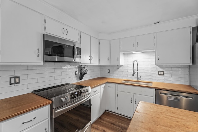 38 Rossie St, Stonington, CT 06355 - kitchen featuring stainless steel appliances, wooden counters, decorative backsplash, dark wood-style floors, and crown molding