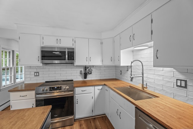 38 Rossie St, Stonington, CT 06355 - kitchen featuring appliances with stainless steel finishes, tasteful backsplash, white cabinetry, and dark wood-style floors