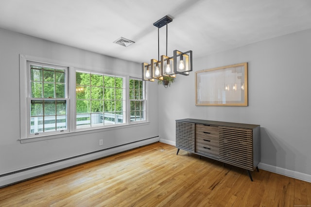 38 Rossie St, Stonington, CT 06355 - unfurnished room featuring baseboard heating, wood finished floors, and a chandelier