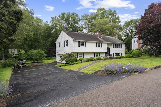 38 Rossie St, Stonington, CT 06355 - view of front of home featuring a chimney, an attached garage, asphalt driveway, and a front lawn