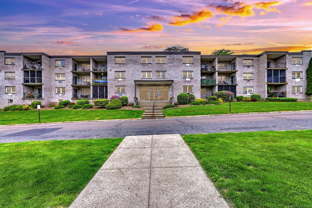 308 Meadowside Rd Apt 101, Milford, CT 06460 - property at dusk featuring a view of apartment building / complex
