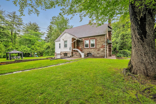 242 Park Ave, Bloomfield, CT 06002 - view of front of home featuring a gazebo, stone siding, a front yard, a chimney, and a shingled roof