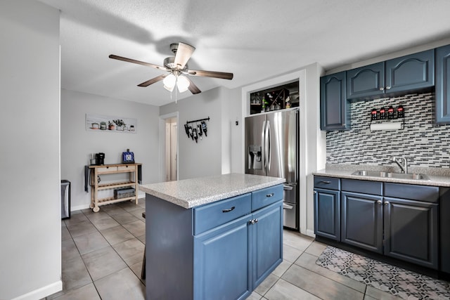 242 Park Ave, Bloomfield, CT 06002 - kitchen with stainless steel fridge with ice dispenser, a sink, blue cabinets, decorative backsplash, and a ceiling fan