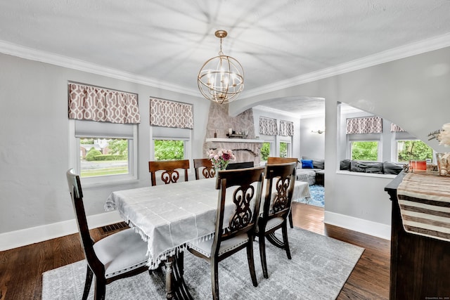 242 Park Ave, Bloomfield, CT 06002 - dining space with arched walkways, a chandelier, ornamental molding, baseboards, and wood finished floors