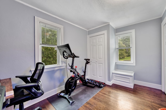 242 Park Ave, Bloomfield, CT 06002 - workout area with crown molding, plenty of natural light, wood finished floors, and baseboards