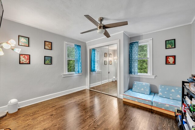 242 Park Ave, Bloomfield, CT 06002 - bedroom featuring wood finished floors, baseboards, ornamental molding, a ceiling fan, and a closet
