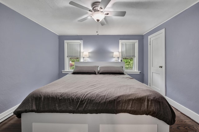 242 Park Ave, Bloomfield, CT 06002 - bedroom featuring wood finished floors, baseboards, multiple windows, ceiling fan, and a textured wall