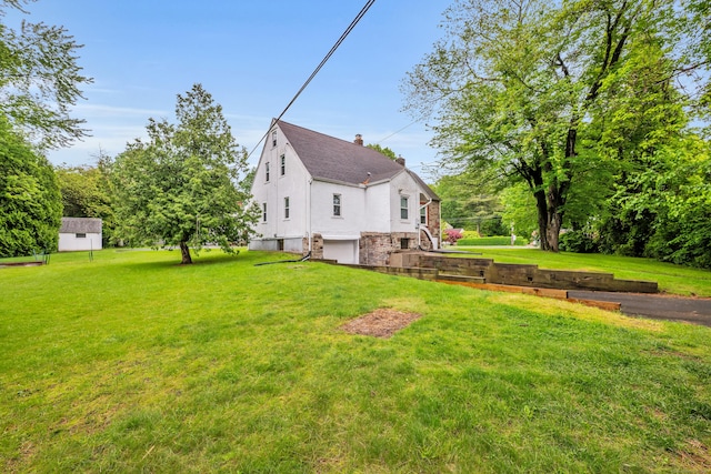 242 Park Ave, Bloomfield, CT 06002 - rear view of property with a garage, a chimney, a yard, and a shingled roof