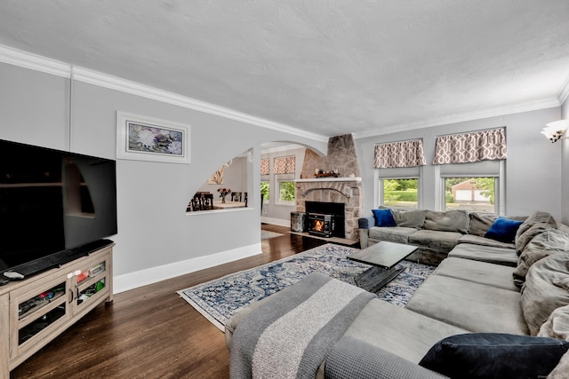 242 Park Ave, Bloomfield, CT 06002 - living room with arched walkways, wood finished floors, ornamental molding, a stone fireplace, and baseboards