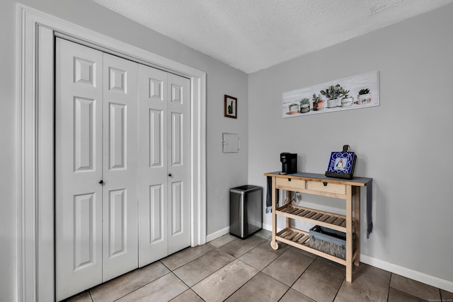 242 Park Ave, Bloomfield, CT 06002 - entrance foyer featuring a textured ceiling, light tile patterned flooring, and baseboards