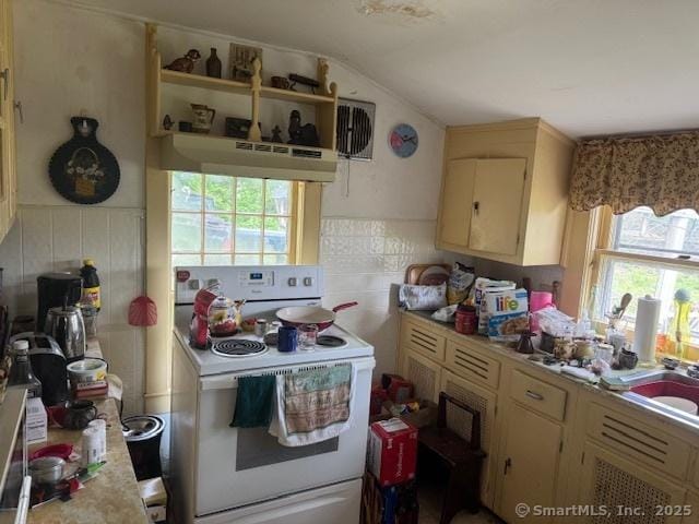 21 Clinic Rd, Pomfret, CT 06230 - kitchen with white electric stove, under cabinet range hood, healthy amount of natural light, light countertops, and vaulted ceiling