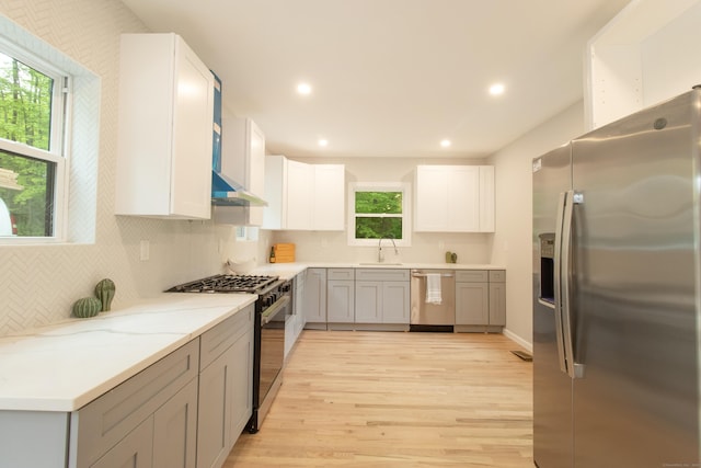 708 County Rd, Guilford, CT 06437 - kitchen featuring appliances with stainless steel finishes, a sink, light wood-type flooring, tasteful backsplash, and recessed lighting