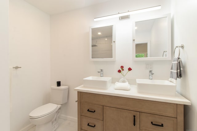 708 County Rd, Guilford, CT 06437 - bathroom with double vanity, toilet, and baseboards