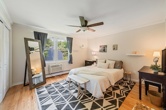 148 Fairway Dr Unit 148, Cheshire, CT 06410 - bedroom with a baseboard heating unit, crown molding, a closet, light wood-style flooring, and baseboards