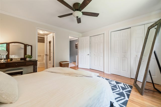 148 Fairway Dr Unit 148, Cheshire, CT 06410 - bedroom with two closets, light wood finished floors, ornamental molding, ensuite bath, and a ceiling fan