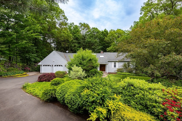 39 Chestnut Hill Rd, Simsbury, CT 06092 - obstructed view of property featuring driveway, an attached garage, and a chimney