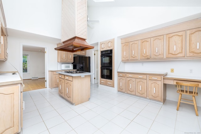 39 Chestnut Hill Rd, Simsbury, CT 06092 - kitchen featuring a towering ceiling, black appliances, light brown cabinetry, a kitchen island, and light tile patterned floors