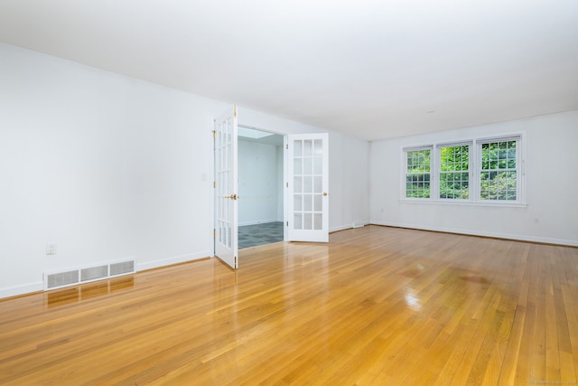 39 Chestnut Hill Rd, Simsbury, CT 06092 - empty room with french doors, light wood-style floors, and baseboards
