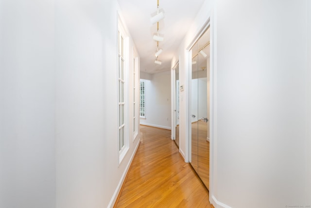 39 Chestnut Hill Rd, Simsbury, CT 06092 - corridor with light wood-style floors, rail lighting, and baseboards
