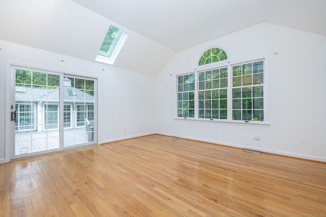 39 Chestnut Hill Rd, Simsbury, CT 06092 - empty room with vaulted ceiling, a skylight, light wood-style floors, and baseboards