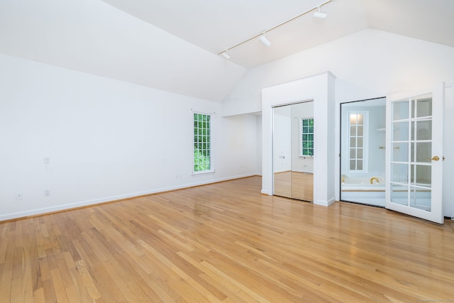39 Chestnut Hill Rd, Simsbury, CT 06092 - unfurnished bedroom featuring rail lighting, lofted ceiling, light wood-type flooring, and baseboards