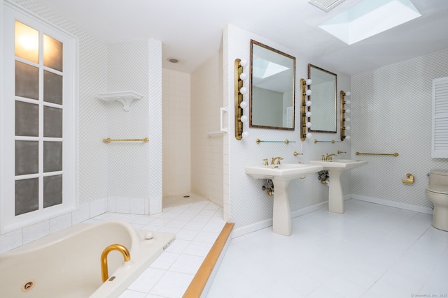 39 Chestnut Hill Rd, Simsbury, CT 06092 - full bathroom with a skylight, a jetted tub, toilet, tile patterned flooring, and a sink