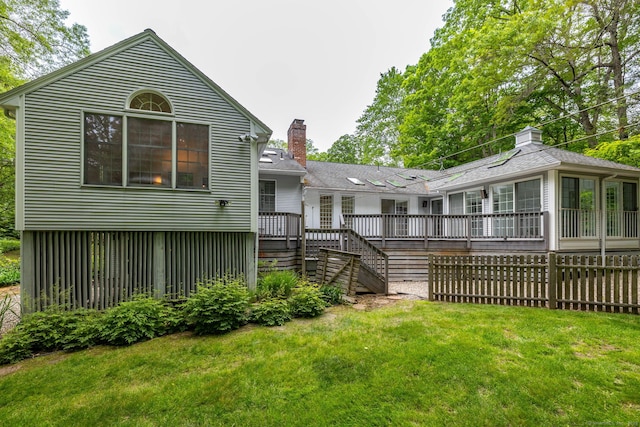 39 Chestnut Hill Rd, Simsbury, CT 06092 - back of property featuring a deck, a chimney, a yard, and stairs