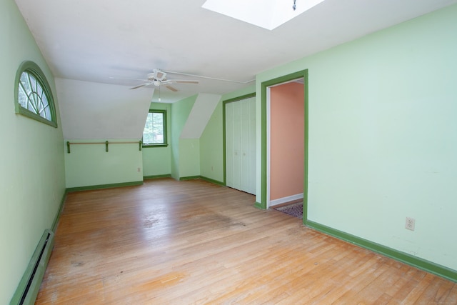 106 Hedgehog Ln, Simsbury, CT 06092 - bonus room with baseboard heating, a skylight, light wood-style flooring, baseboards, and a ceiling fan