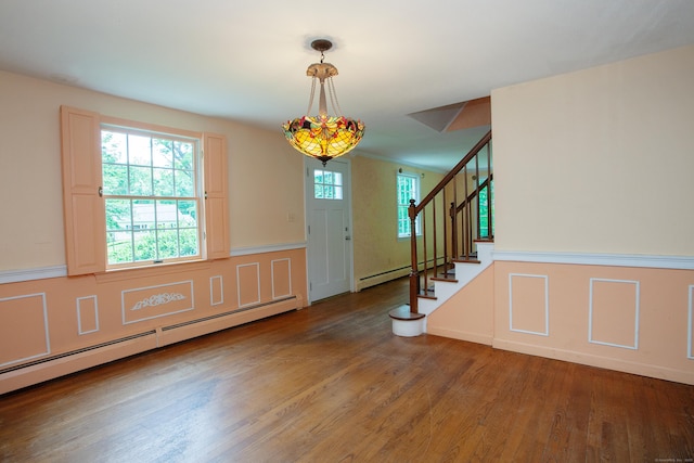 106 Hedgehog Ln, Simsbury, CT 06092 - entryway featuring a baseboard heating unit, wood finished floors, a wainscoted wall, stairway, and a decorative wall