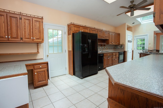 106 Hedgehog Ln, Simsbury, CT 06092 - kitchen featuring black appliances, a ceiling fan, a skylight, a sink, and light tile patterned floors