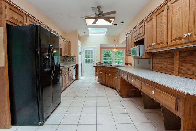 106 Hedgehog Ln, Simsbury, CT 06092 - kitchen with black appliances, a skylight, ceiling fan, and brown cabinets