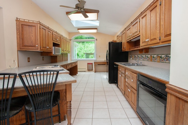 106 Hedgehog Ln, Simsbury, CT 06092 - kitchen featuring a sink, a skylight, lofted ceiling, light countertops, and black appliances