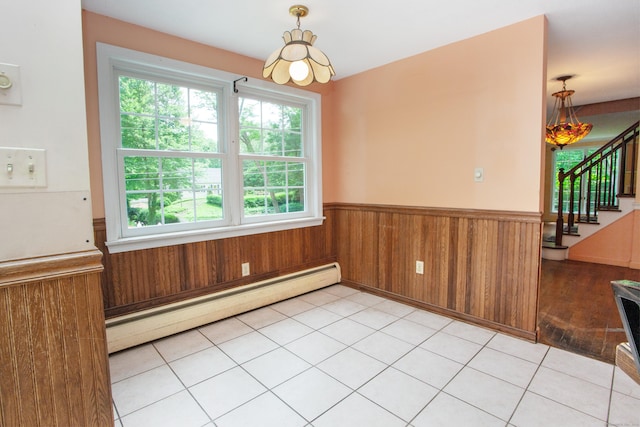 106 Hedgehog Ln, Simsbury, CT 06092 - unfurnished dining area with a baseboard heating unit, a wainscoted wall, stairway, plenty of natural light, and wooden walls