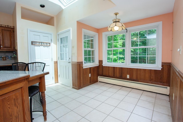 106 Hedgehog Ln, Simsbury, CT 06092 - dining space with a baseboard heating unit, wainscoting, a skylight, wood walls, and light tile patterned flooring
