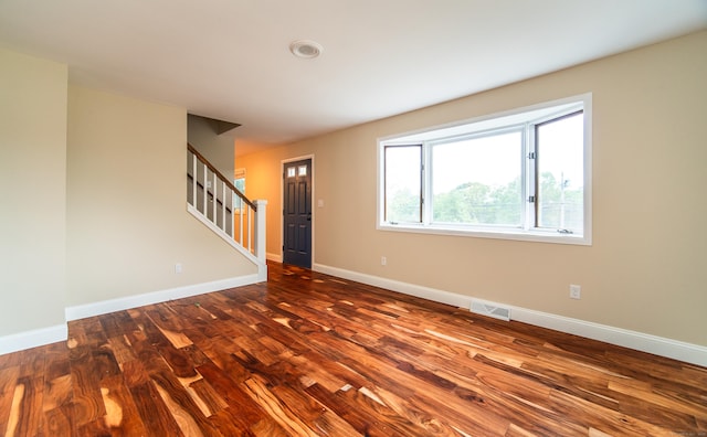 251 Forest Rd, North Branford, CT 06472 - unfurnished room featuring dark wood-style flooring, stairway, and baseboards