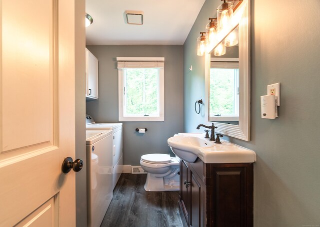 251 Forest Rd, North Branford, CT 06472 - bathroom with washer and dryer, wood finished floors, toilet, vanity, and baseboards
