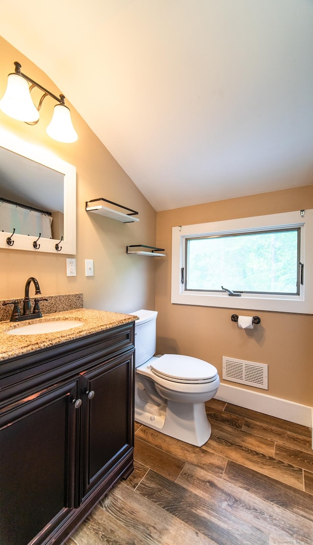 251 Forest Rd, North Branford, CT 06472 - bathroom with vanity, toilet, wood finished floors, and lofted ceiling