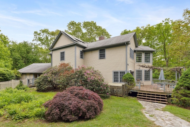 143 Petticoat Ln, East Haddam, CT 06423 - view of side of property with a chimney, a wooden deck, a pergola, and roof mounted solar panels