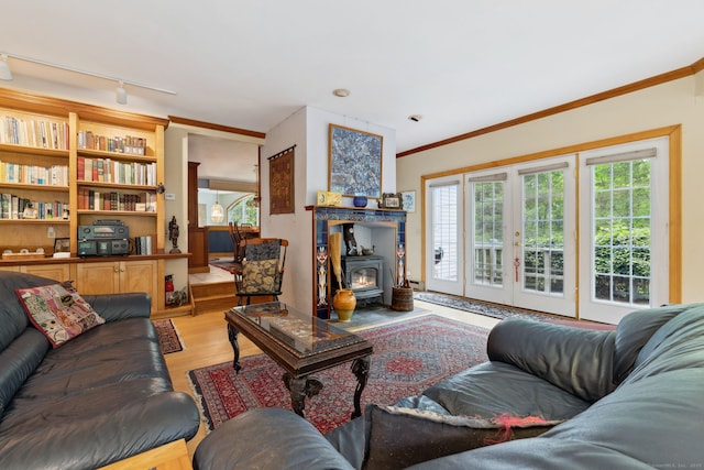 143 Petticoat Ln, East Haddam, CT 06423 - living room featuring ornamental molding, light wood-type flooring, a wood stove, rail lighting, and french doors