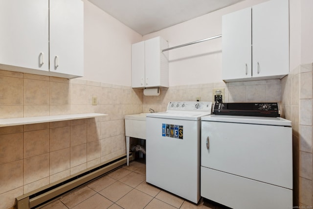 143 Petticoat Ln, East Haddam, CT 06423 - washroom featuring cabinet space, washing machine and dryer, tile walls, baseboard heating, and light tile patterned floors
