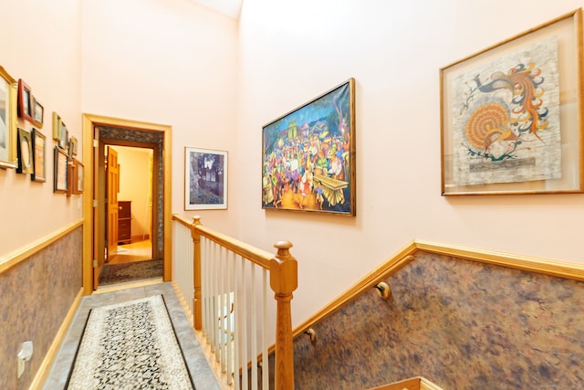 143 Petticoat Ln, East Haddam, CT 06423 - hall with an upstairs landing, tile patterned flooring, and a wainscoted wall