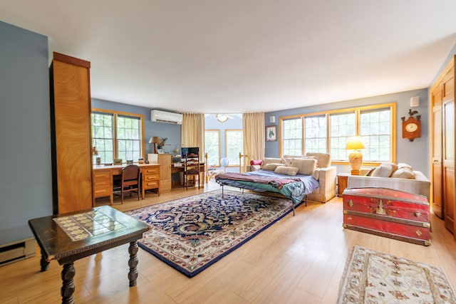 143 Petticoat Ln, East Haddam, CT 06423 - living area featuring a wall mounted AC, healthy amount of natural light, and light wood-type flooring