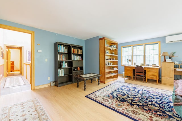 143 Petticoat Ln, East Haddam, CT 06423 - office featuring an AC wall unit, built in desk, light wood-style floors, and baseboards