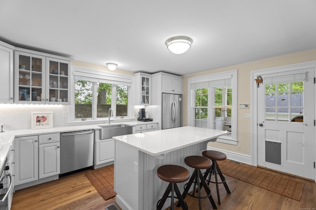 9 Rathbun Pl, Groton, CT 06355 - kitchen with appliances with stainless steel finishes, a sink, a kitchen breakfast bar, and light wood finished floors
