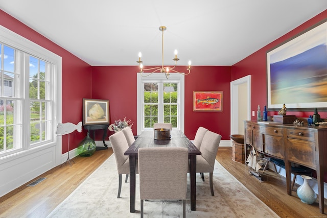 9 Rathbun Pl, Groton, CT 06355 - dining space with healthy amount of natural light, wood finished floors, a chandelier, and baseboards